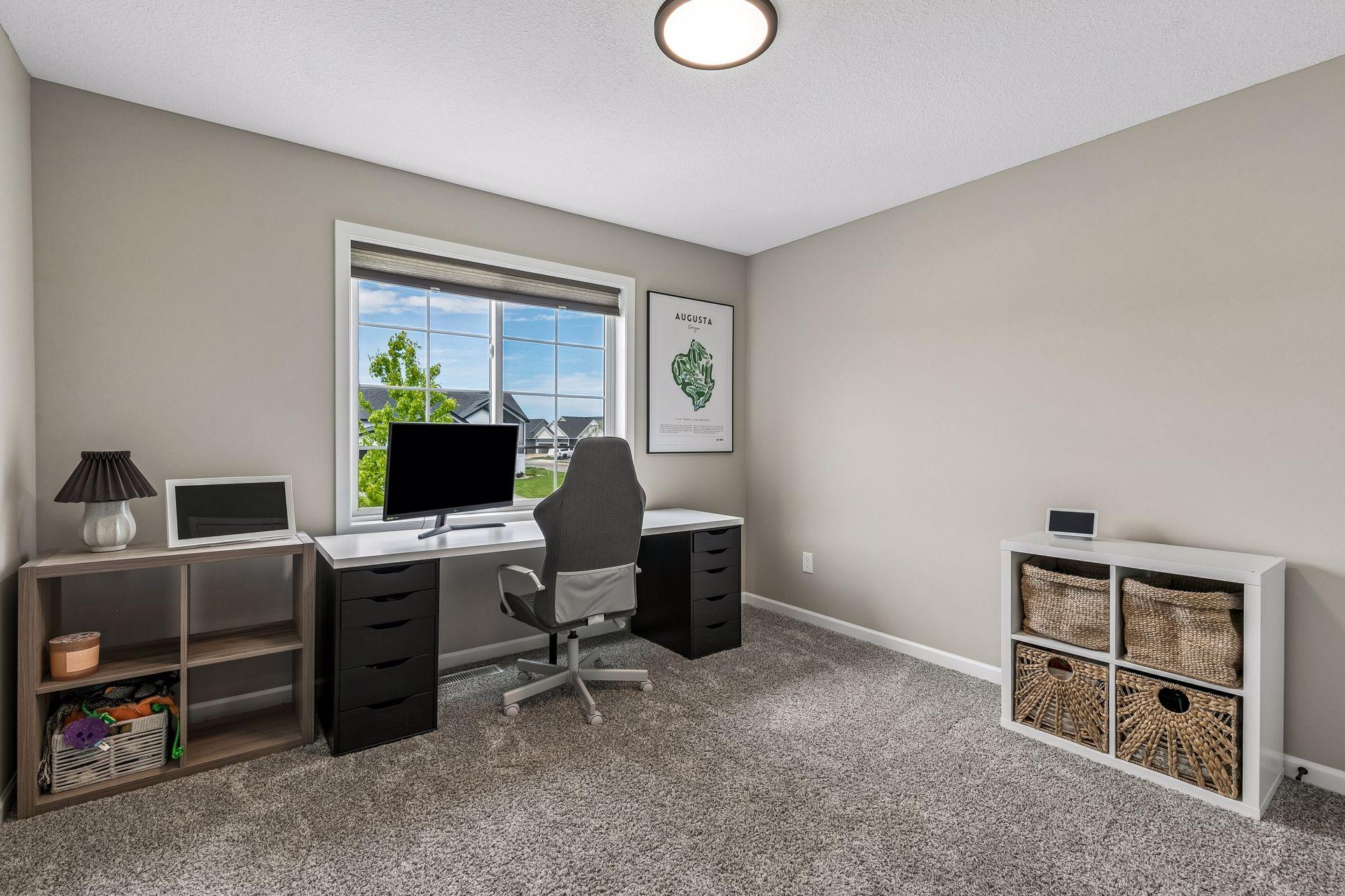 Bedroom #2 on the upper level that has various uses. As shown here it was a home office! Very spacious and great views out your window.