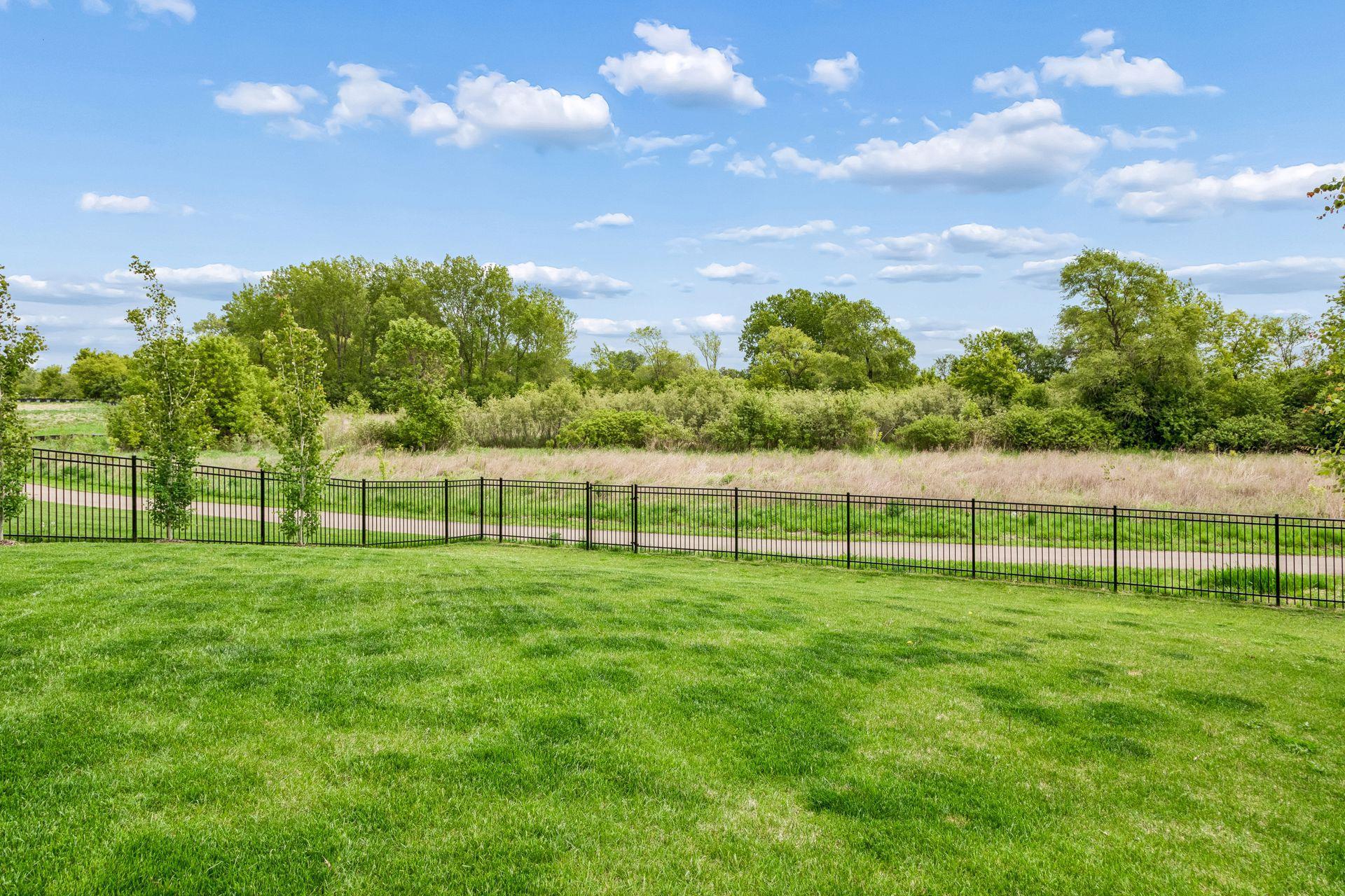 Fenced in backyard that was added by the homeowners and backs to a walking path.