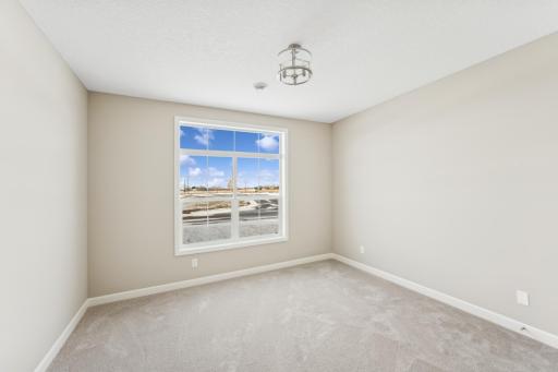 Front bedroom - photos are of a staged home of similar floorplan, selections/colors may differ
