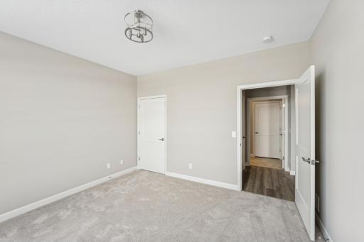 Front bedroom - photos are of a staged home of similar floorplan, selections/colors may differ
