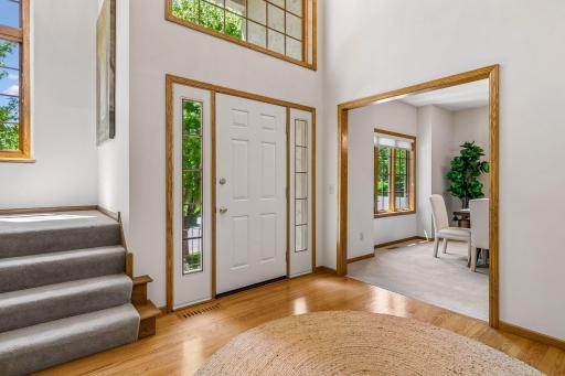 Impressive 2 story foyer creates a great first impression. New light chandeliers and fresh, neutral paint throughout add to the appeal.