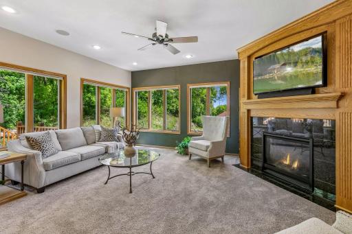 Yummy main floor family room boasts custom gas fireplace with built-ins surrounding. Note the abundant windows. Really a lovely vibe!