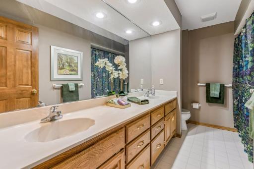 Large hall bath offers huge double vanity and combo tub/shower.