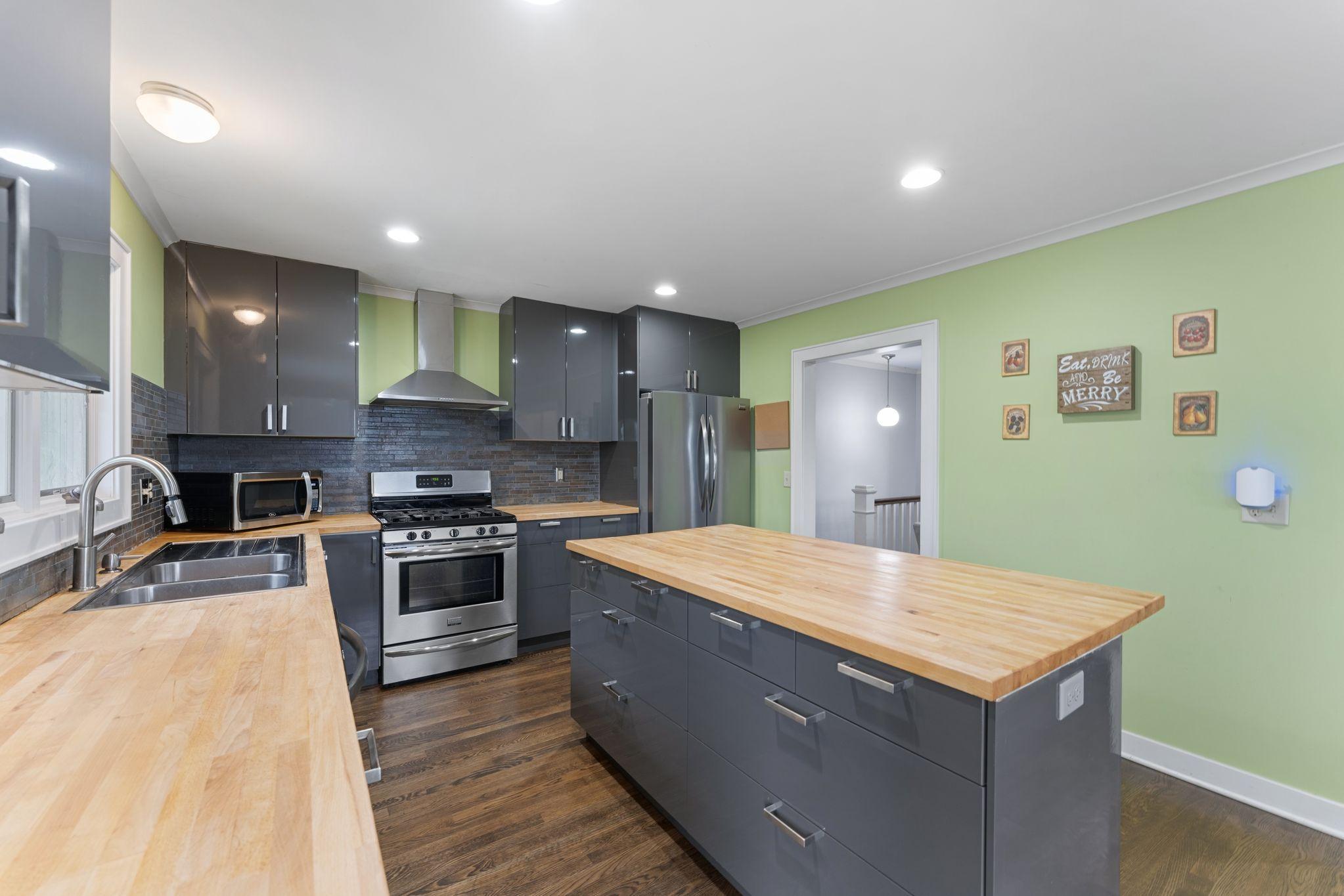 Kitchen with gas range and range hood
