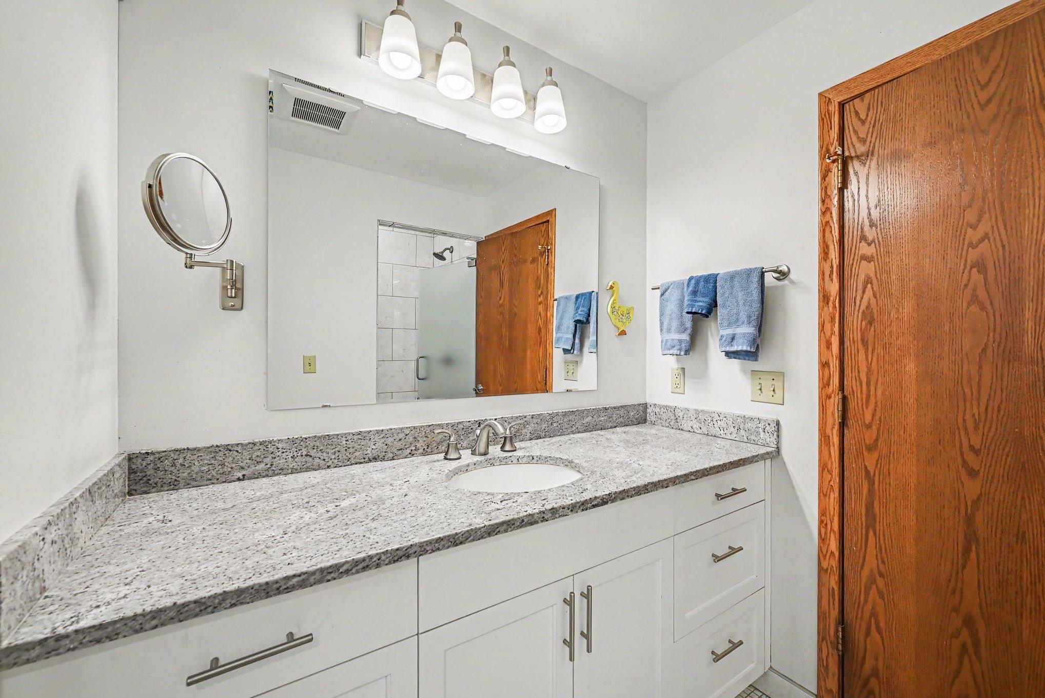 Custom tiled 3/4 primary with built-in shelves.