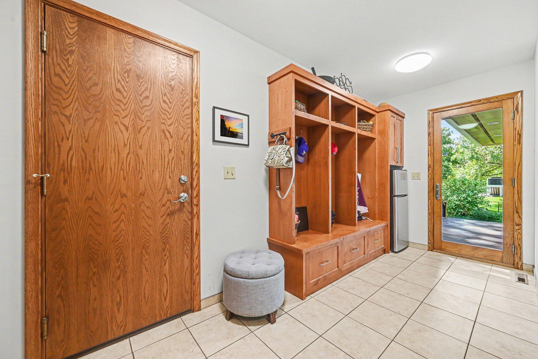 A huge 6' x 14' mudroom between the kitchen, garage, and back deck. Door access to west side deck has convenient beverage fridge for all your favorite chilled beverages.
