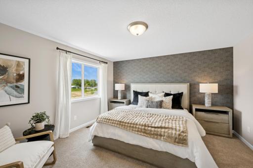 Primary bedroom - photo of a staged model home of the same floorplan