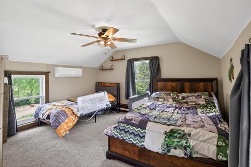 Spacious upper level bedroom with vaulted ceilings.