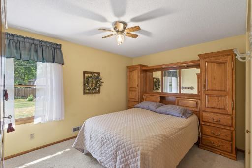 Bedroom #1 features a ceiling fan, closet & a window.