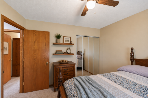 Bedroom #2 features a ceiling fan, closet & window.