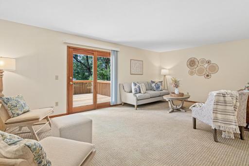 The main floor living room is large, light filled and walks out to an expansive multi-level deck that has all new deck boards!