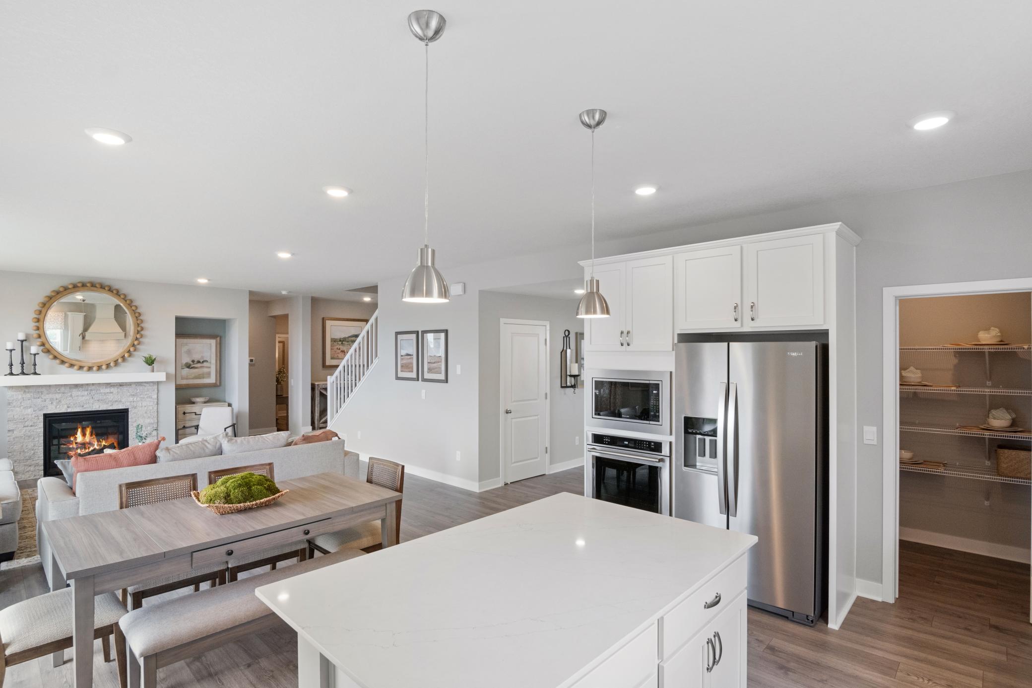 A walk in pantry offers extra storage! Photo of prior model home, colors and finishes will vary.