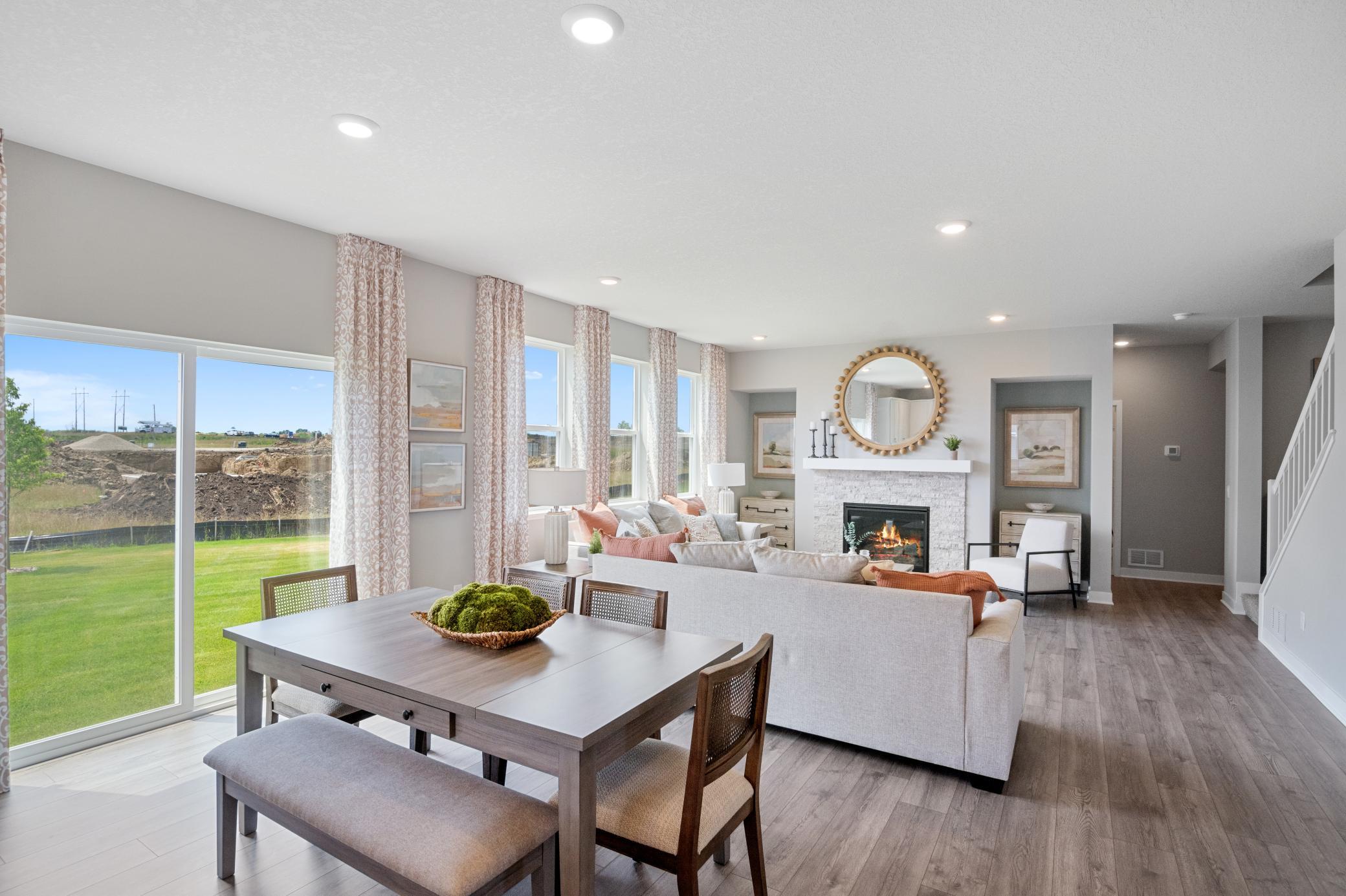 An informal dining space joins the kitchen and living room. Photo of prior model home, colors and finishes will vary.