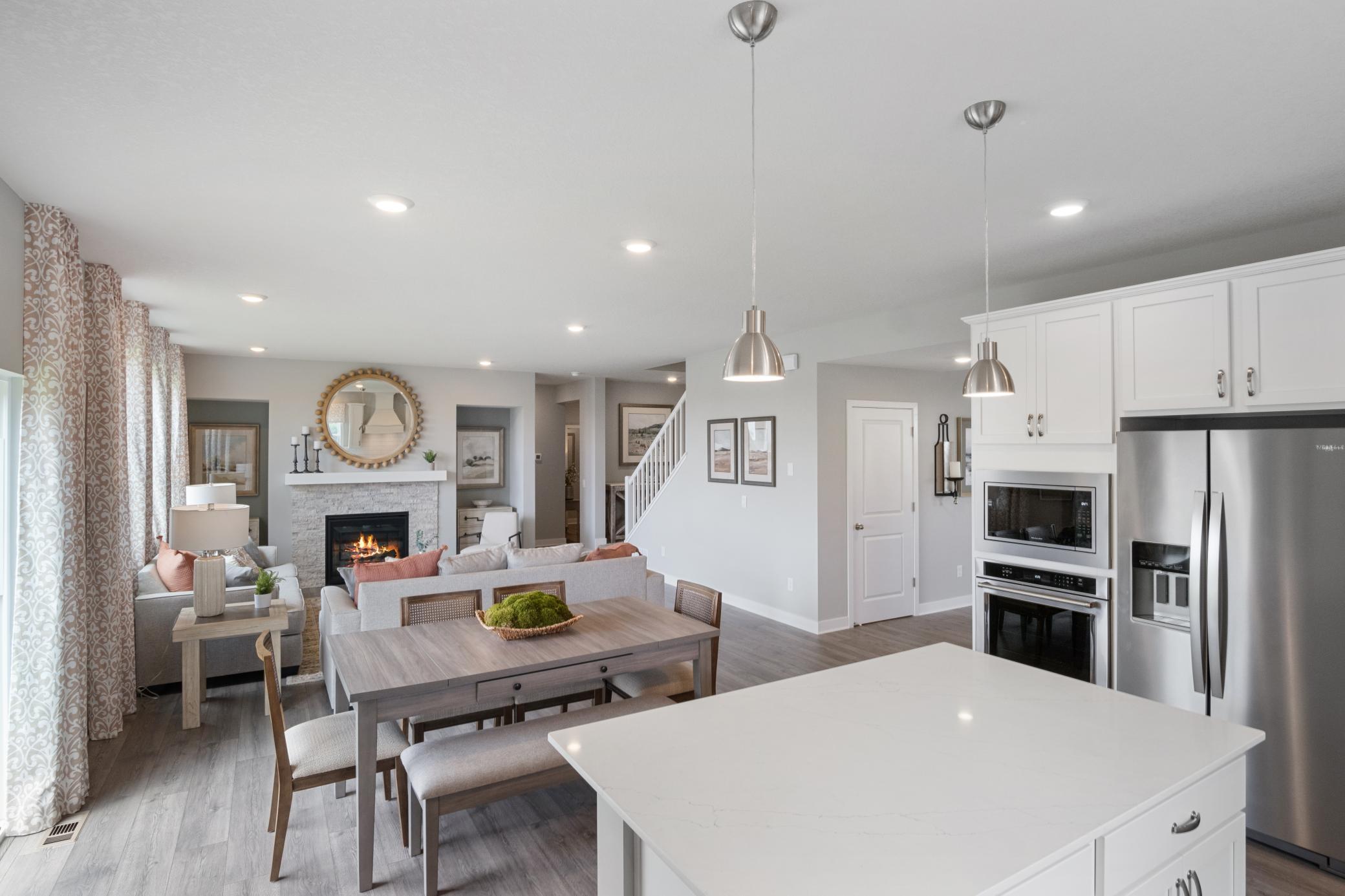 Kitchen opens to the rest of the main living space. Photo of prior model home, colors and finishes will vary.