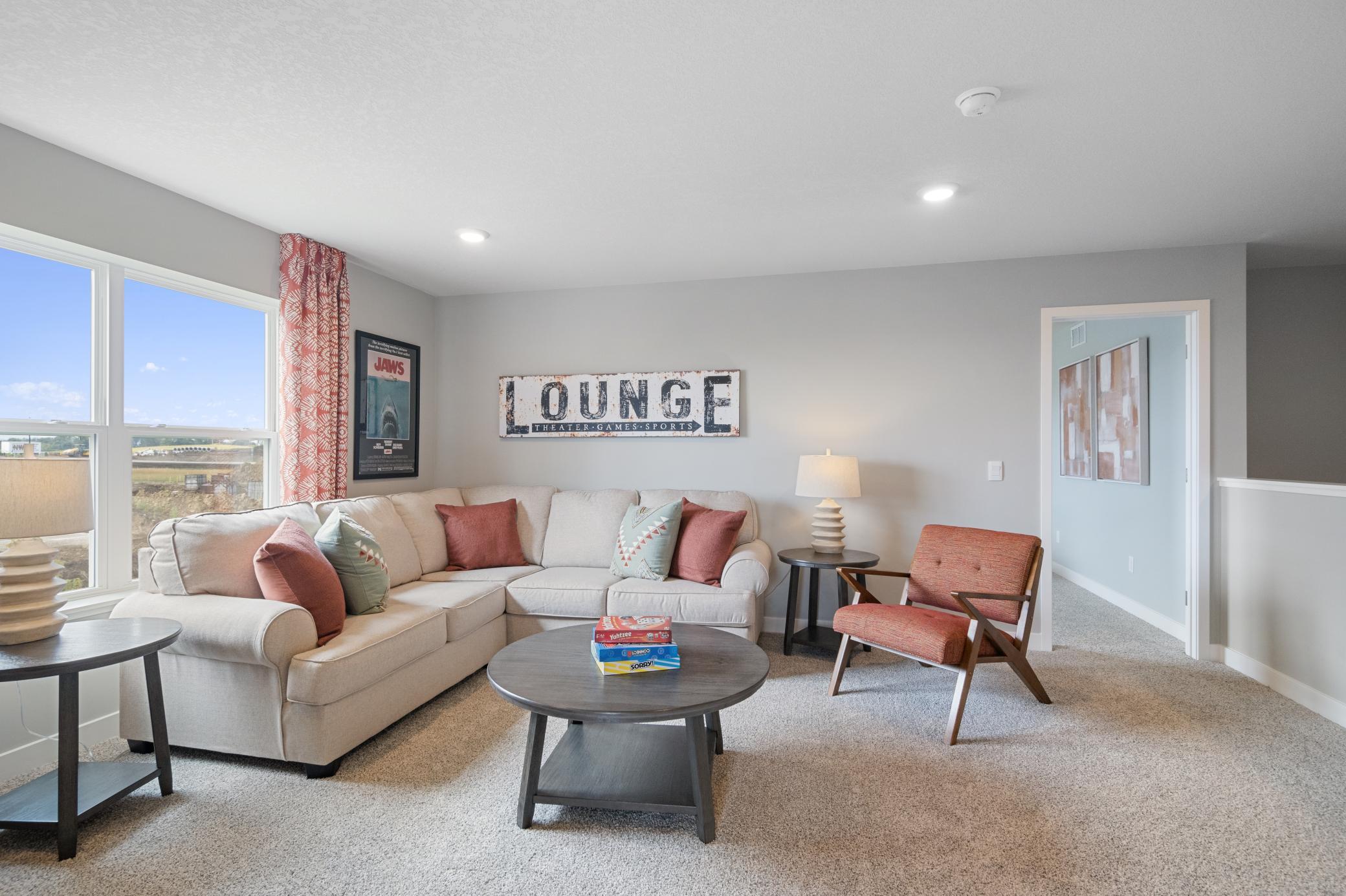 Loft on the upper level serves as a second family room. Photo of prior model home, colors and finishes will vary.