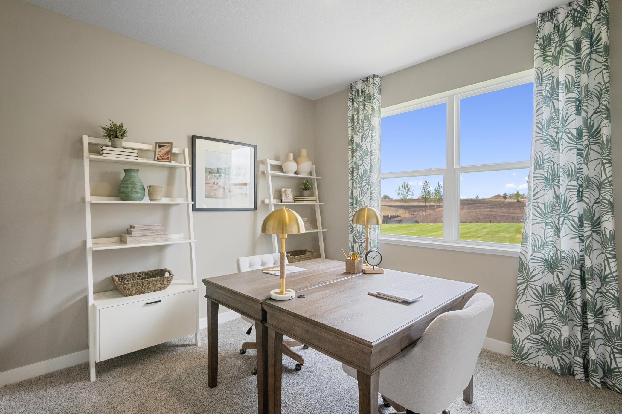 Main floor ensuite bedroom or office. Photo of prior model home, colors and finishes will vary.
