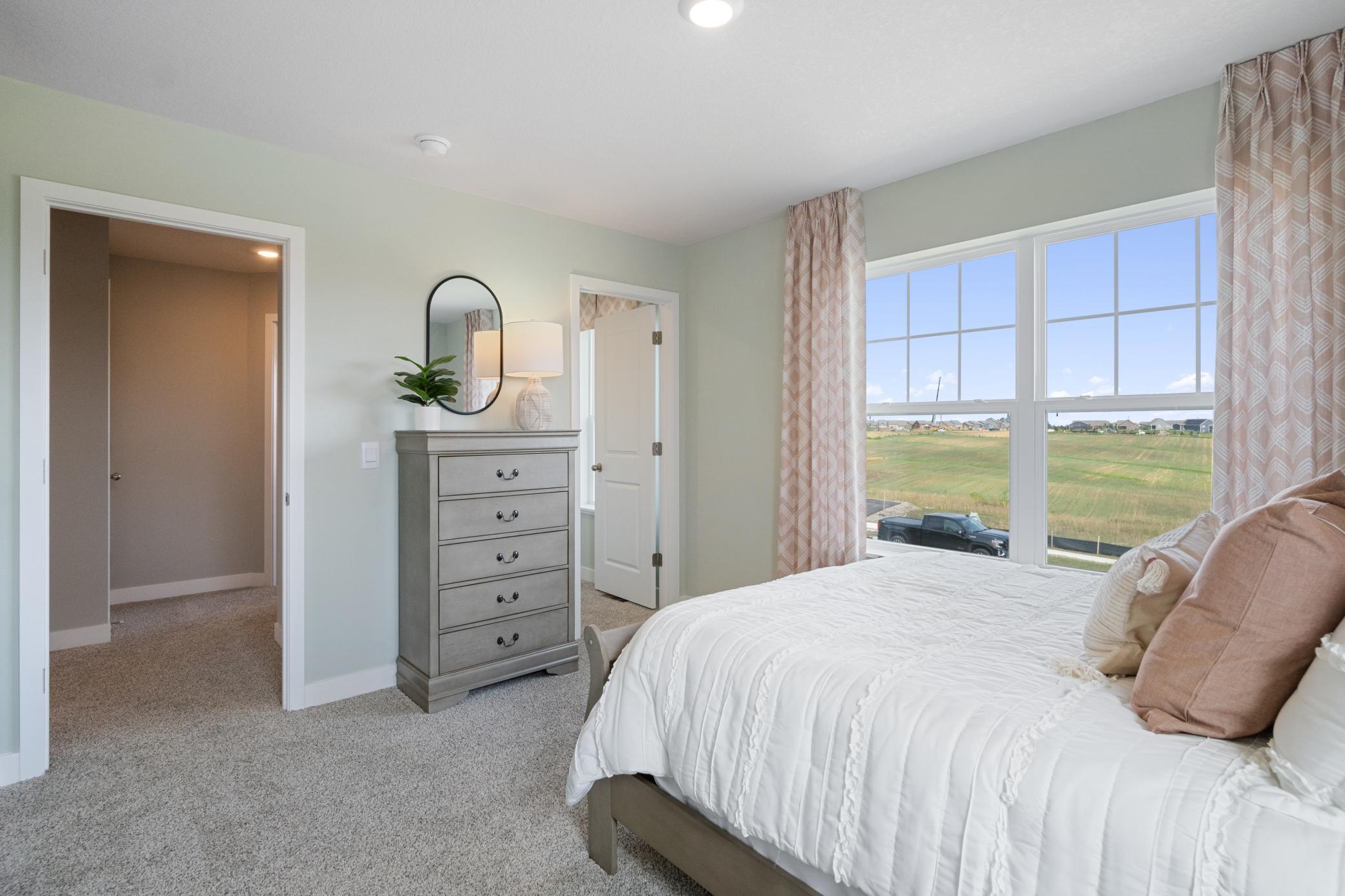 Upper level bedroom, another view. Photo of prior model home, colors and finishes will vary.
