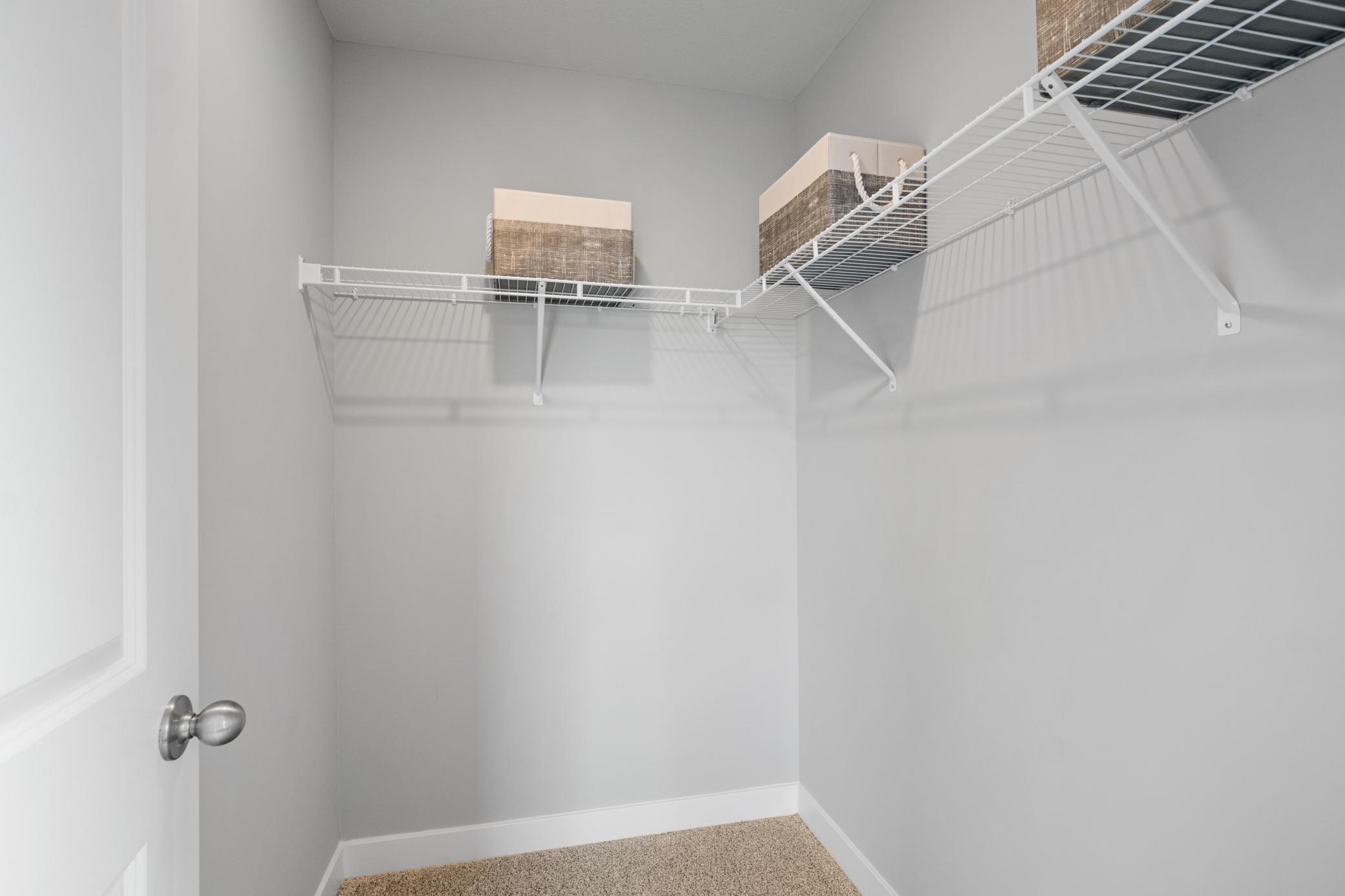 All upper level bedrooms have a walk in closet. Photo of prior model home, colors and finishes will vary.
