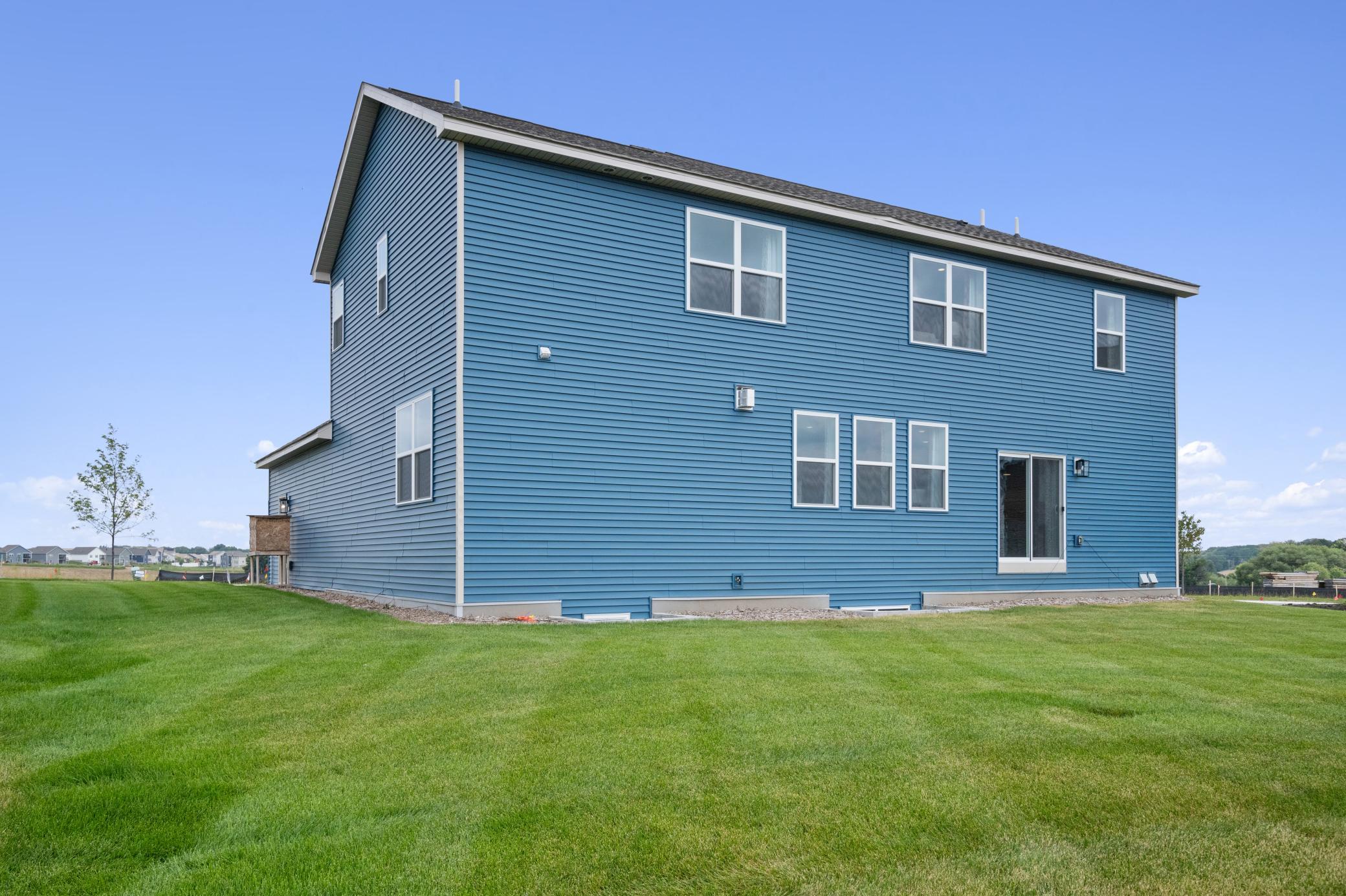We offer walkout home sites as well. Sod and irrigation included. Photo of prior model home, colors and finishes will vary.