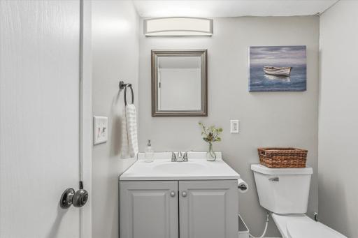 Lower level updated bathroom w/fresh paint, flooring and vanity.