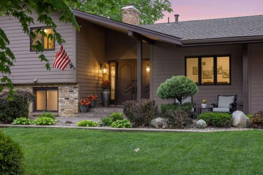The established neighborhood has large landscaped lots with mature trees.