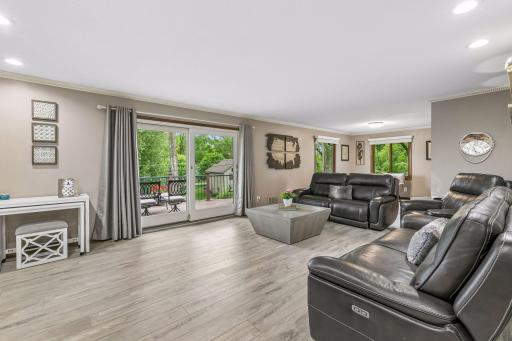 The living room has recently updated LVP floors with a sliding door that leads to the deck.