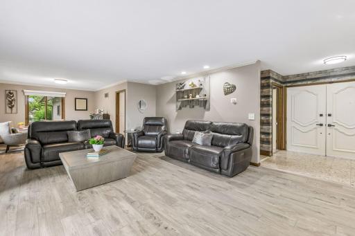 The living room is open to a flex space that could be used as a formal dining area or for additional seating.