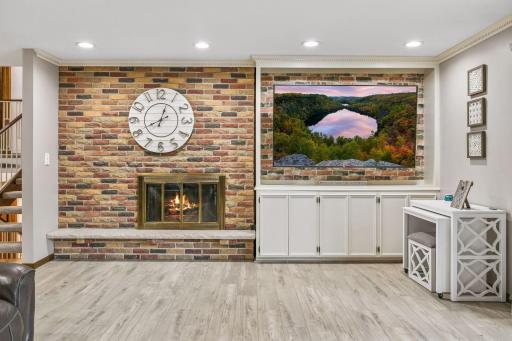 The gas fireplace with brick surround is the focal point of the room.