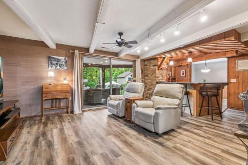 There is a wet bar and a sliding door that opens to the backyard.