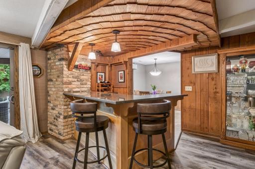The wet bar has brick accents and a fabulous cedar shake ceiling treatment.