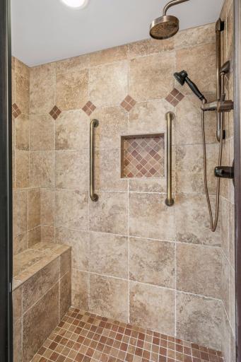Here is the custom tile shower with a seat and a dual rainfall shower system.