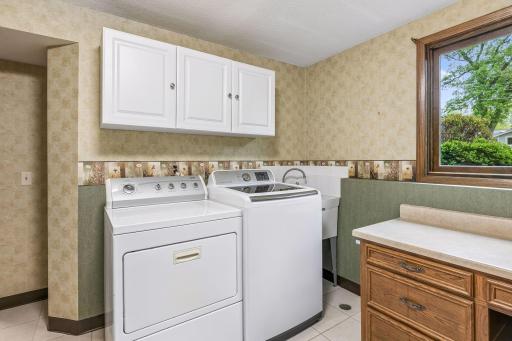 The large laundry room is on the lower level. There is abundant cabinet storage and a sink.