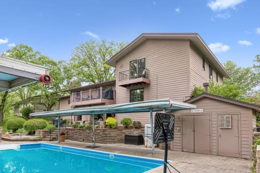 The pool house to the right has an outdoor shower and stores the pool equipment. The pool heater was updated in 2021.