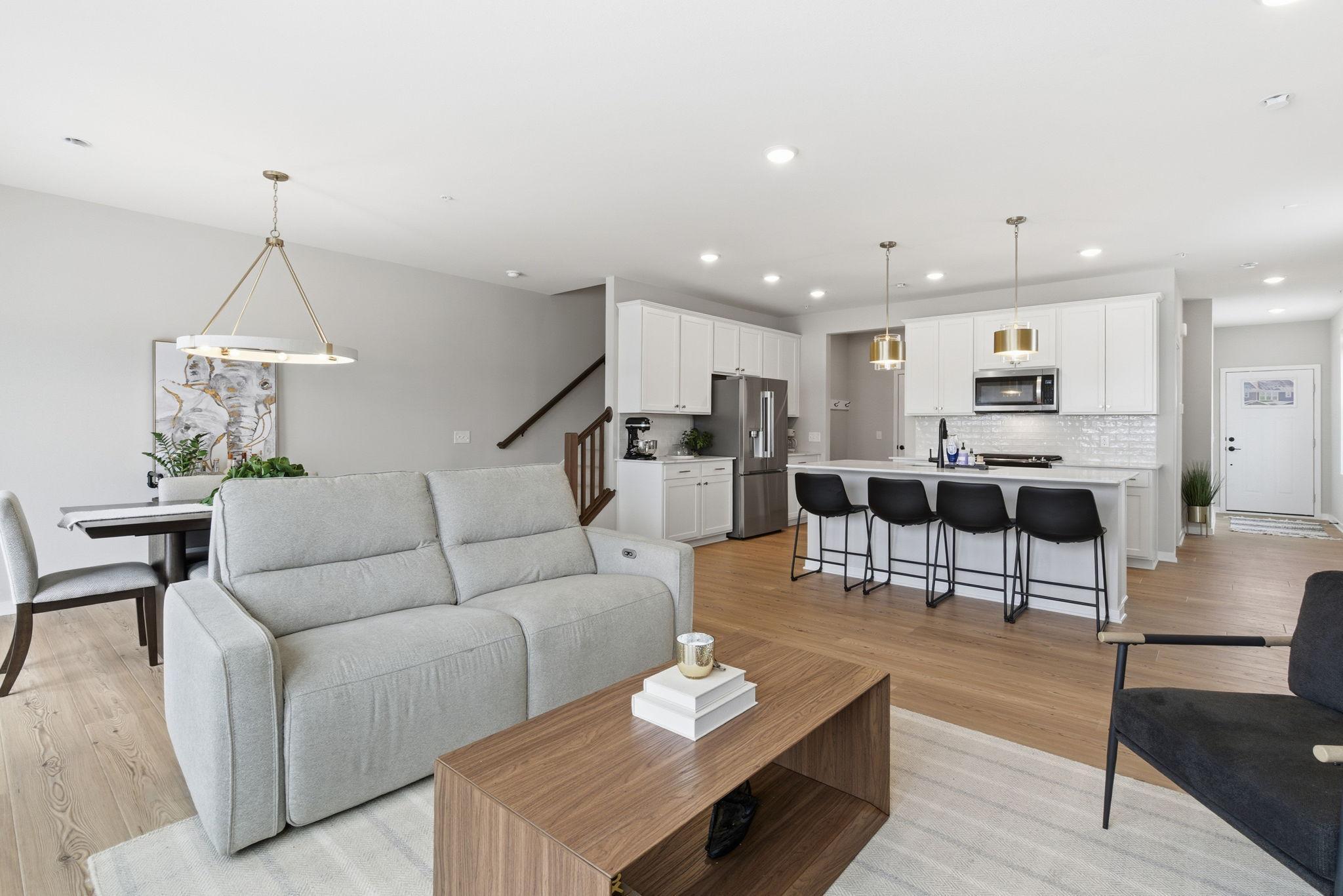 The open-concept main level is ideal for both everyday living and entertaining. A spacious living area flows seamlessly into the gourmet kitchen with a statement island and refined finishes, while the adjoining dining space offers flexibility & ease.
