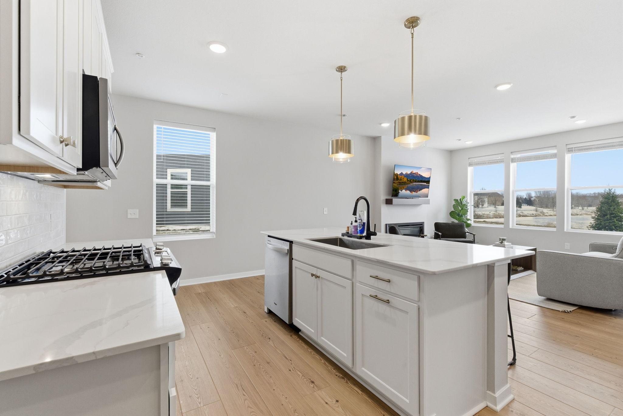 Wide-plank luxury vinyl floors and an open-concept layout enhance both flow and functionality, making this kitchen ideal for upscale entertaining and everyday elegance.