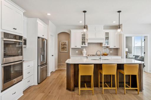 Our gourmet kitchen defines how the WOW comes standard. With a huge center island, granite countertops, gas cook top, and double ovens, plus so much more! (Photo of a previously built Summit Floorplan)