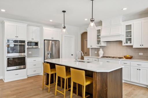 All our features are standard including the granite countertops, tile backsplash and under mount kitchen sinks. (Photo of a previously built Summit Floorplan)