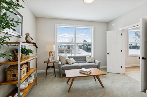 Just off the kitchen is the sun room. Use it as a reading nook or a place for your kids to play. (Photo of a previously built Summit Floorplan)