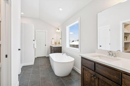 The luxurious, private bath comes with a freestanding tub. (Photo of a previously built Summit Floorplan)