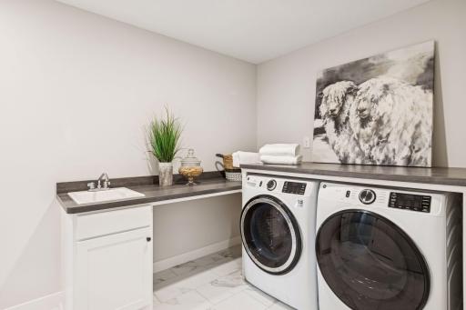Having the laundry room near all the upper level bedrooms makes laundry day a little bit easier. (Photo of a previously built Summit Floorplan)