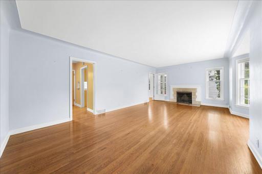 Final view of Living Room looking into back hallway & door leading into the eat-in dining room/large kitchen area!
