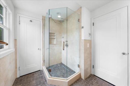 Additional View of 3/4 Bath show casing the Walk in shower and doors leading to hallway and primary bedroom