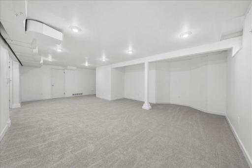 Additional view Of lower level family room door on far wall leads into the utility room