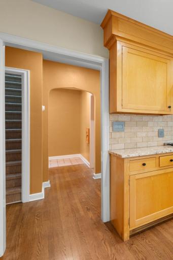 View of the back Hallway leading to Main Floor Full Bath, 2 main floor bedrooms, and both staircases leading to Upper and Lower Levels of the home.