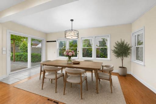 View of Dining Room off of the Kitchen looking out onto large Deck/Private back yard - Virtually Staged!