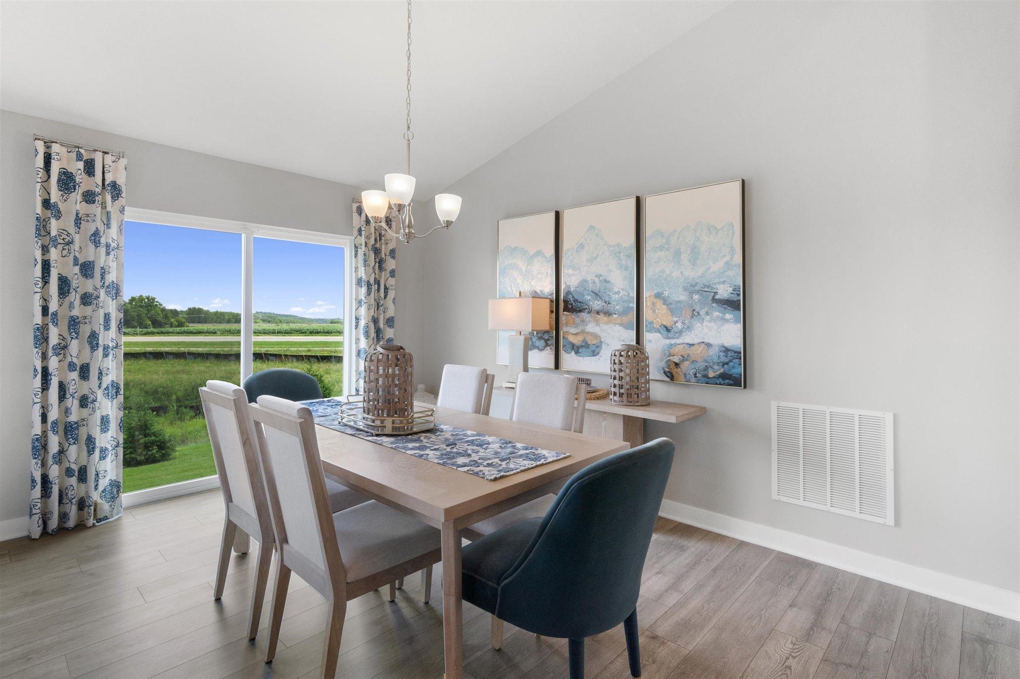 Dining room on the main level, this informal space is large enough to accommodate just about any dining room table configuration! Photo is of actual home. Colors and options may vary. Ask Sales Agent for details.