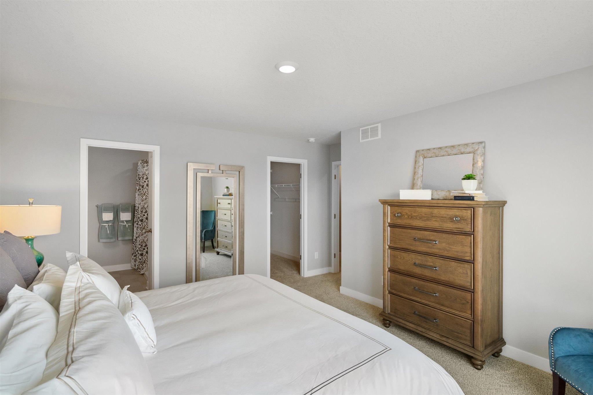 Another view of the Owner's suite with bathroom en-suite. Photo is of actual home. Colors and options may vary. Ask Sales Agent for details.