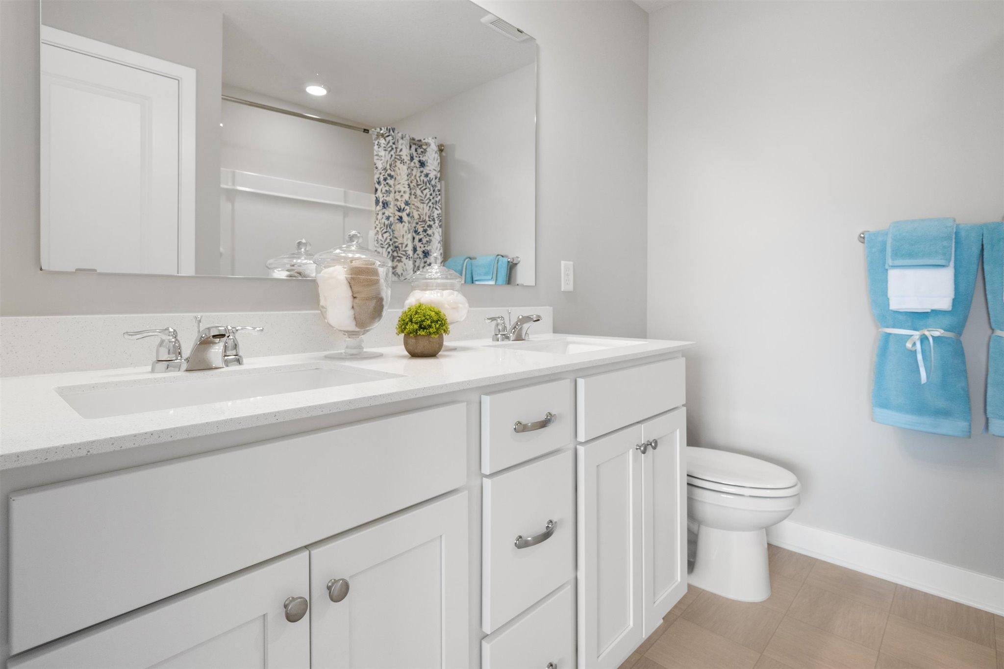 Dual sinks in primary bathroom. Photo of actual home. Colors and options may vary. Ask Sales Agent for details.