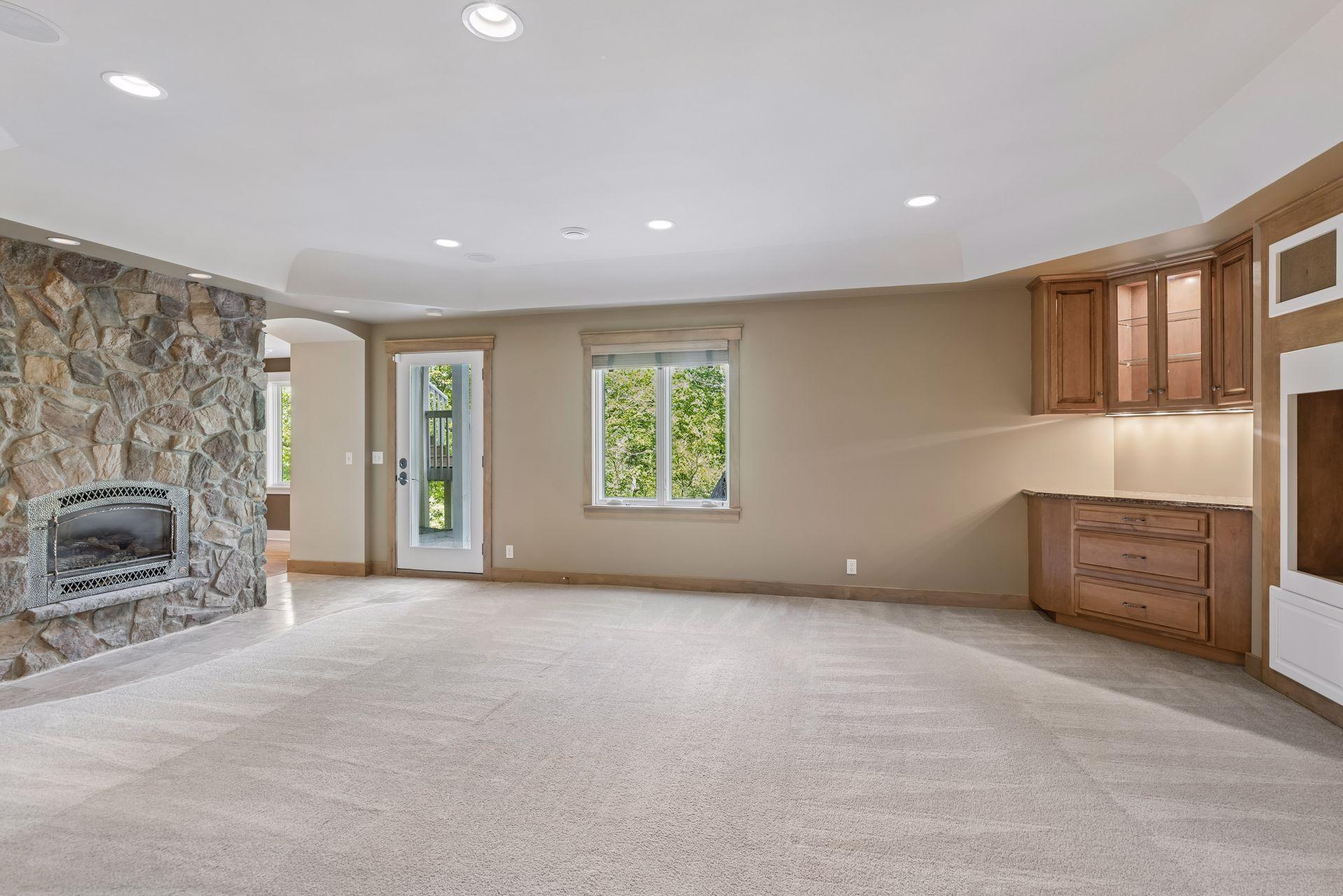 Lower level family room with gas fireplace, wet bar, walkout to paver patio