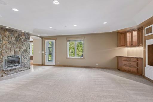 Lower level family room with gas fireplace, wet bar, walkout to paver patio